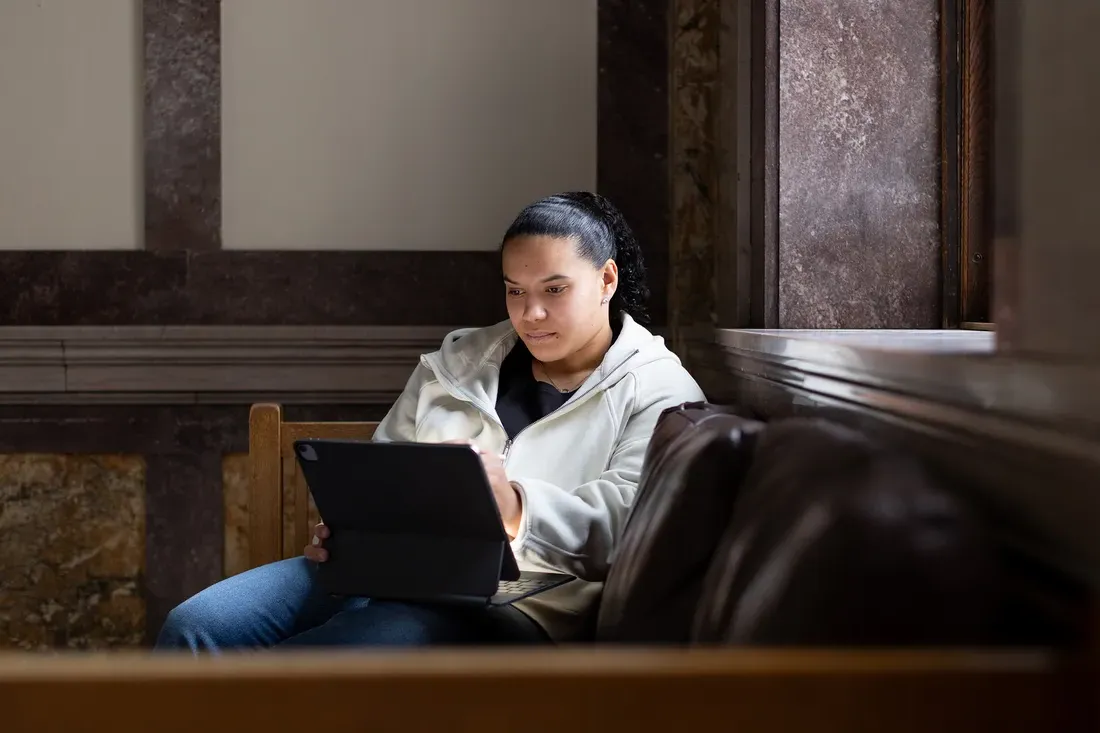 Person sitting and studying on couch.